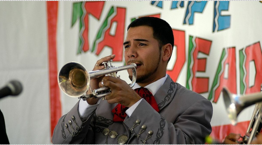 Photo from a past Tempe Tardeada celebration of a person playing an instrument