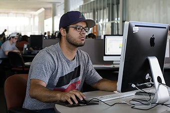 A student working on a computer inside Coor Hall