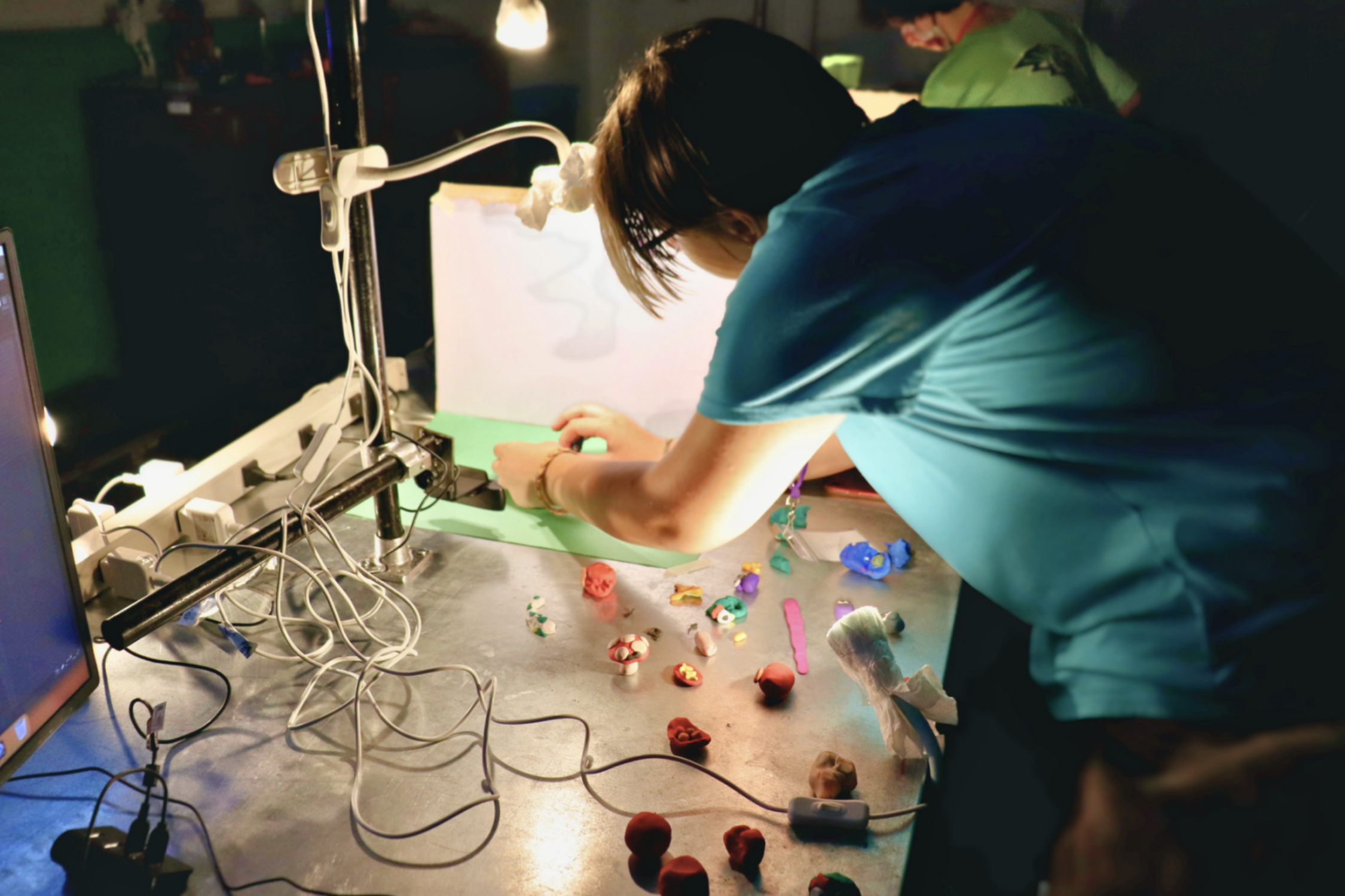 A student manipulates items for their stop motion animation video