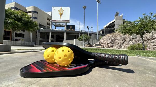 Large tennis racket in front of Sun Devil Stadium